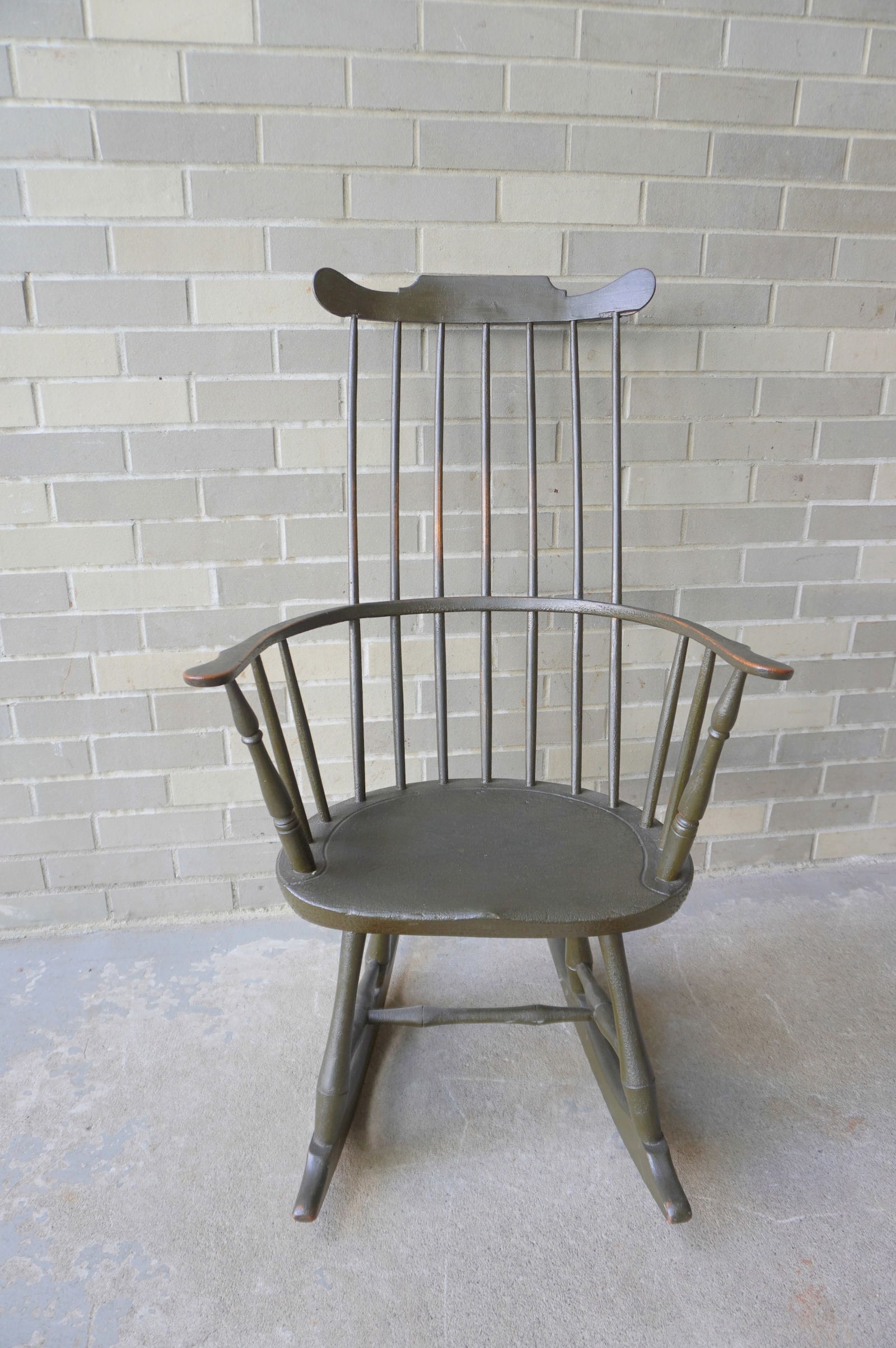 A good Windsor fan-back rocker in old crusty dark green paint which appears to be original as are: A good Windsor fan-back rocker in old crusty dark green paint which appears to be original as are the rockers, good condition, late 18th century. Measures 23"W x 24"D x 40 1/2"H.