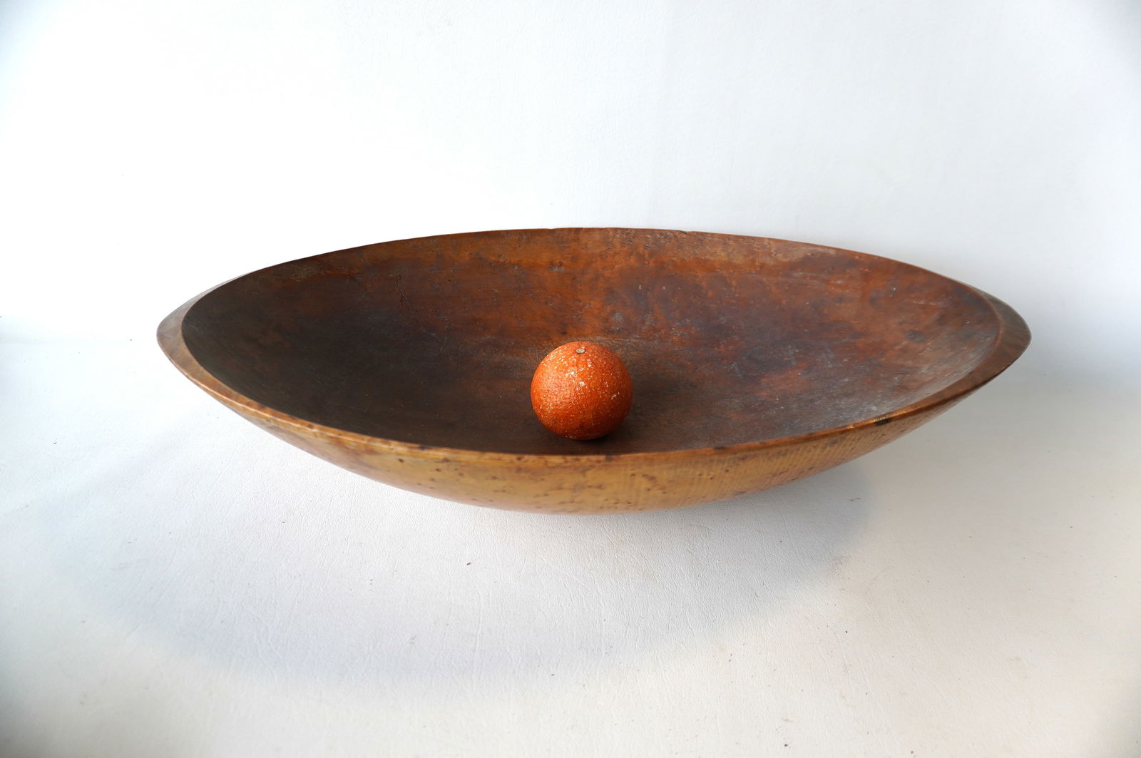 An oval birdseye maple treenware bowl showing normal use wear and in very good original condition,: An oval birdseye maple treenware bowl showing normal use wear and in very good original condition, early to mid 19th century. Measures 23 1/2"L x 14"W x 5"H. Provenance: From the Marni Bakst and Willi