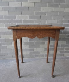 An early oak Queen Ann tea table with shaped apron, tray top, and original pad feet. Refinished, but