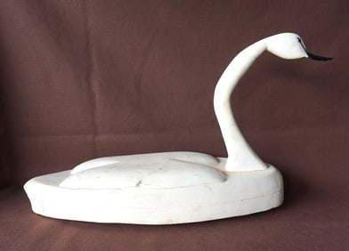 A folk art carved wooden life-size swan decoy in old white paint which appears to be original,