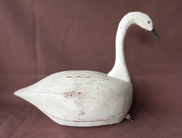 A folk art carved wooden life-size swan decoy in old white paint which appears to be original. The