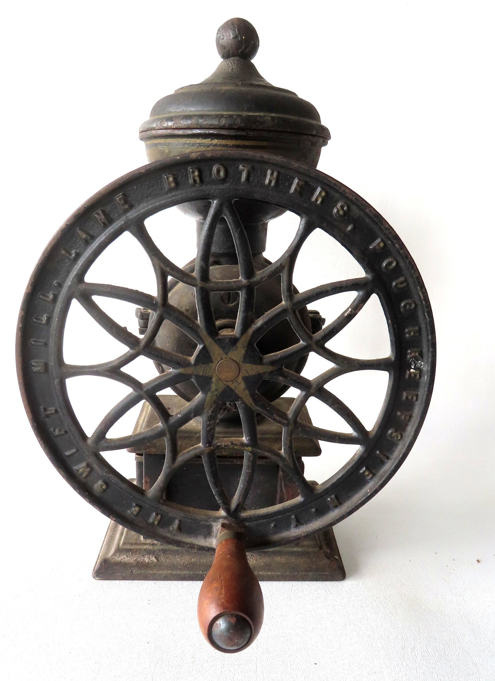 Cast iron coffee mill, single wheel, signed "The Swift / Lane Brothers Poughkeepsie N.Y.". Black: Cast iron coffee mill, single wheel, signed "The Swift / Lane Brothers Poughkeepsie N.Y." with patent date of May 20, 1918. Black and gold paint which appears to be original and overall good condition