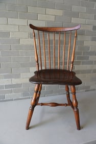 A fan-back Windsor side chair with 9 turned spindles, saddle seat, and turned cross stretchers,