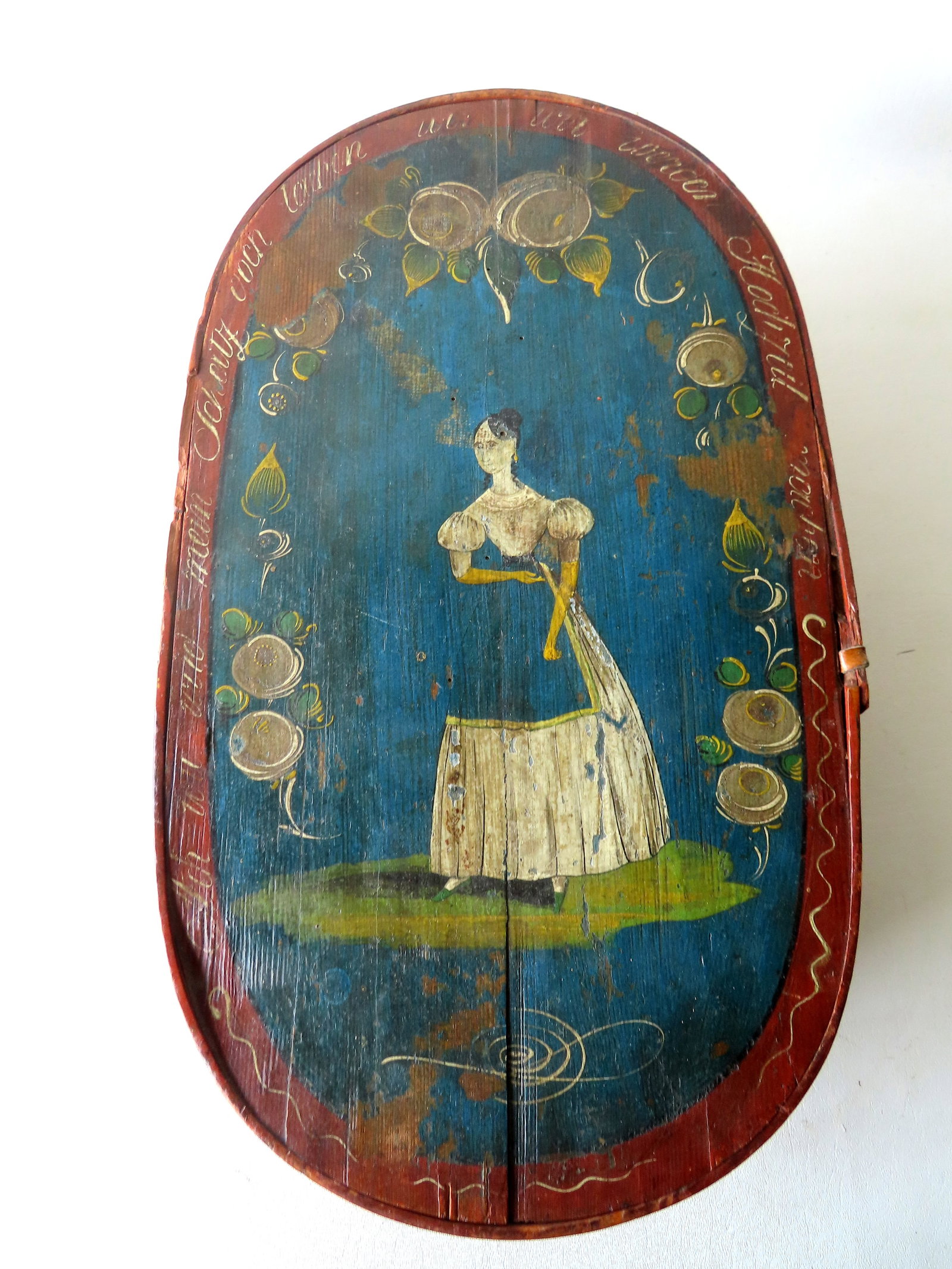 A Scandinavian bride's box, the lid decorated with a lady wearing apron surrounded by flowers and: A Scandinavian bride's box, the lid decorated with a lady wearing apron surrounded by flowers and with Scandavian writings around the border. The apron of bottom section decorated with stylized flower