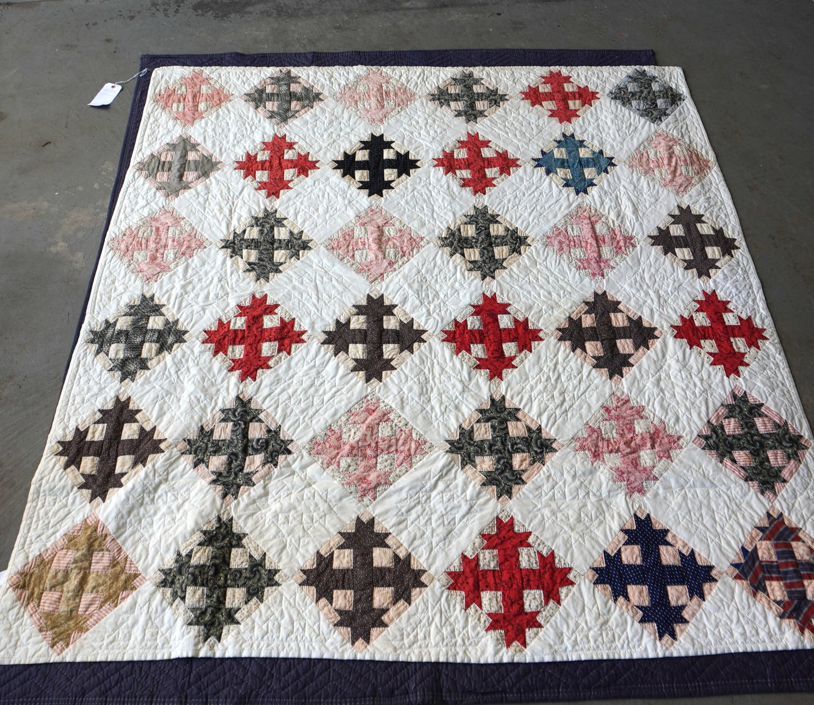 A patchwork quilt, stars in a diamond pattern, very good condition. Early 20th century. Measures 70": A patchwork quilt, stars in a diamond pattern, very good condition. Early 20th century. Measures 70" x 72". Provenance: From the June & Bernard Pierce estate, Hyde Park NY.