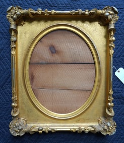 An outstanding classical gilt gesso portrait frame with oval inset, and decorated with nuts, fruit