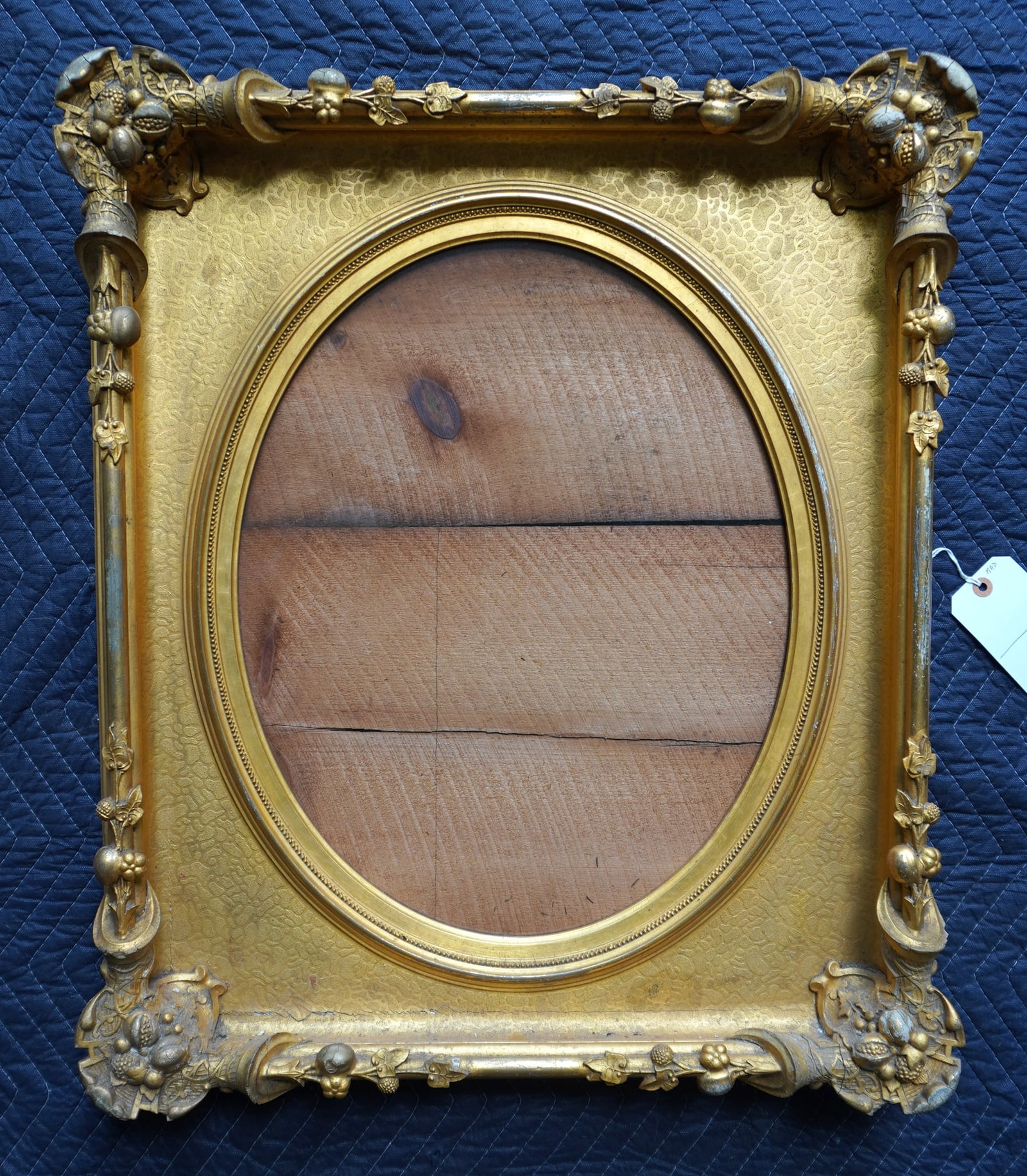 An outstanding classical gilt gesso portrait frame with oval inset, and decorated with nuts, fruit: An outstanding classical gilt gesso portrait frame with oval inset, and decorated with nuts, fruit and berries on vine, circa 1850-60. Very good original condition. Sight size within oval 15 3/8" x 19