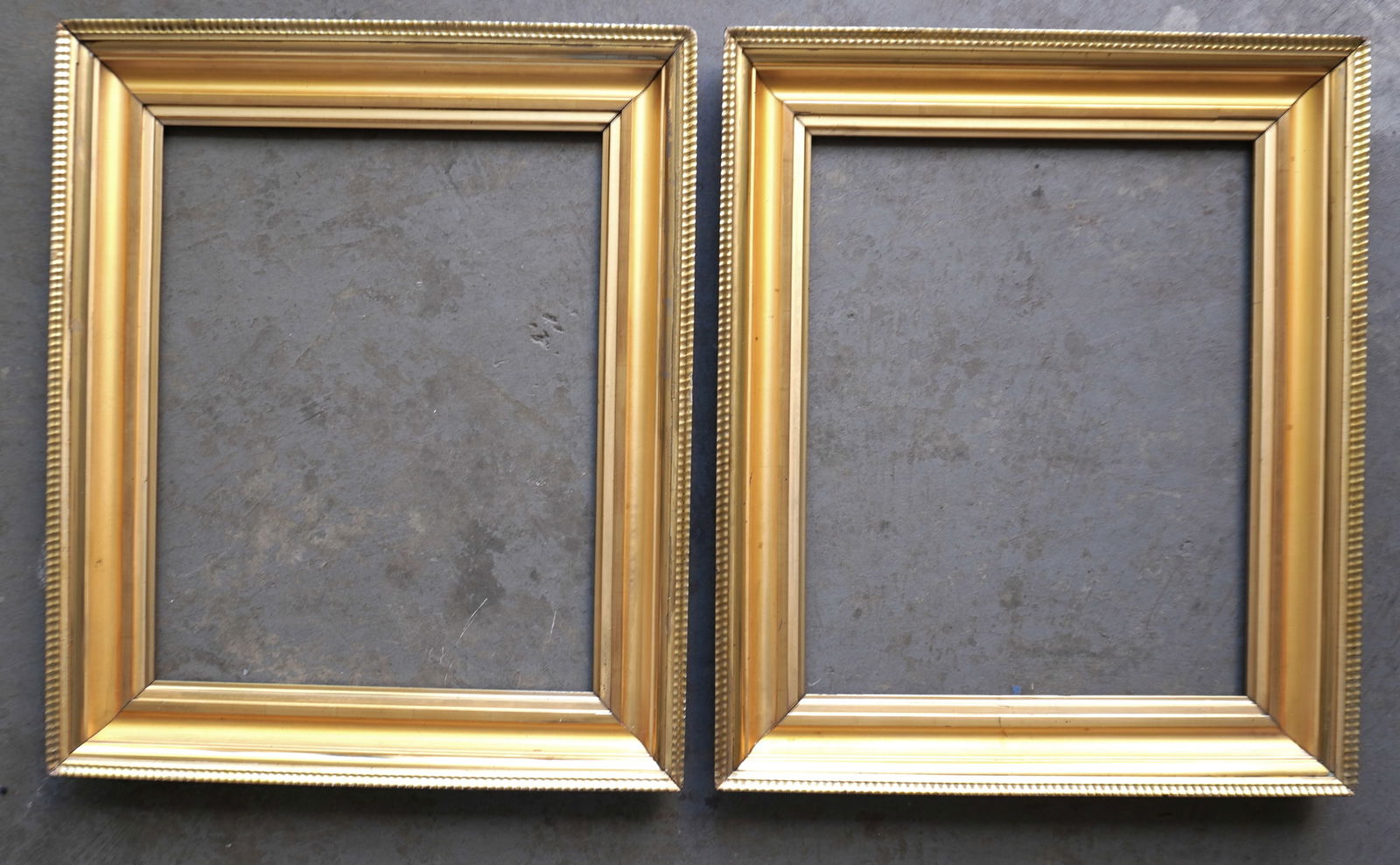 Two good matching lemon gold portrait frames, 1830-50, both with minor use wear in corners, else in: Two good matching lemon gold portrait frames, 1830-50, both with minor use wear in corners, else in very good condition - the opening 21 1/2" x 26 3/4" and total frame size of each 28 3/4" x 34 1/4".