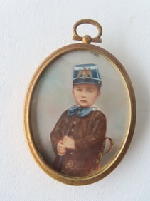 Miniature W/C portrait of a young boy in military outfit which includes kepi with eagle insignia,