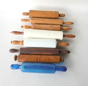A grouping of 8 vintage rolling pins including in 1 in white porcelain, 1 in white molded milkglass,