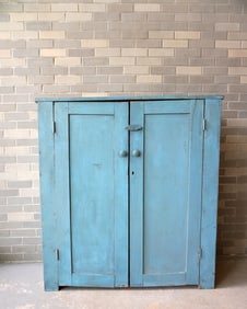 A primitive 2 door cupboard in old blue paint - some paint touchup - the interior shelves have all