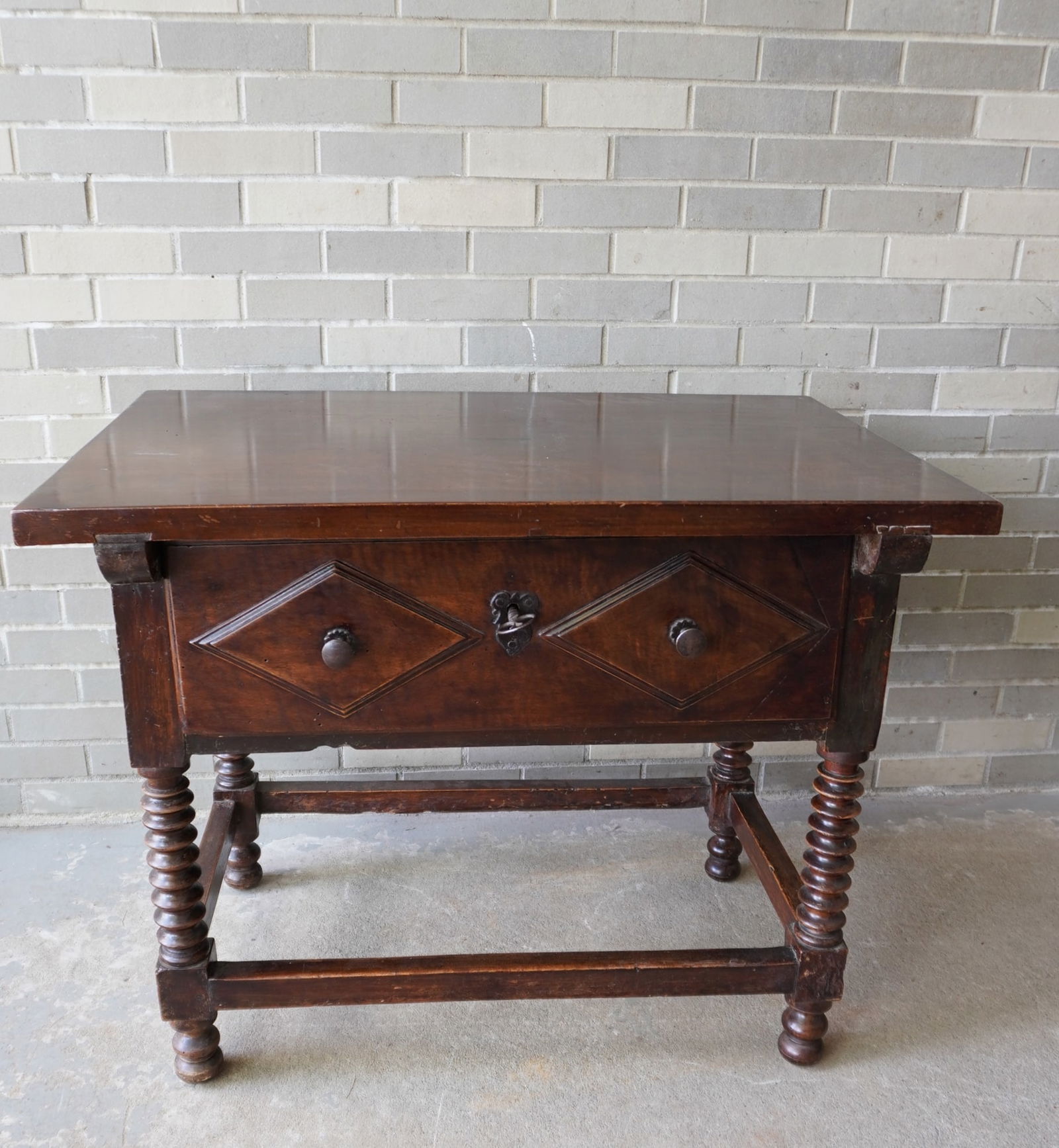 An early continental work table with single drawer, original hand forged lock and key, cross: An early continental work table with single drawer, original hand forged lock and key, cross stretchers and spool turned legs. The top is key into the frame. The table appears to be 18th century that