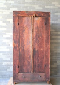 A primitive pine pantry cupboard having 2 doors over 1 drawer, square nail construction, late 19th
