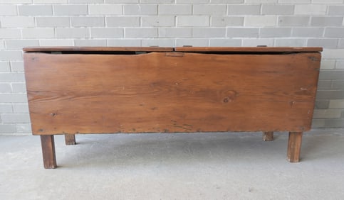 A primitive pine storage bin with 2 lids mounted on rectangular form legs, mid 19th century or