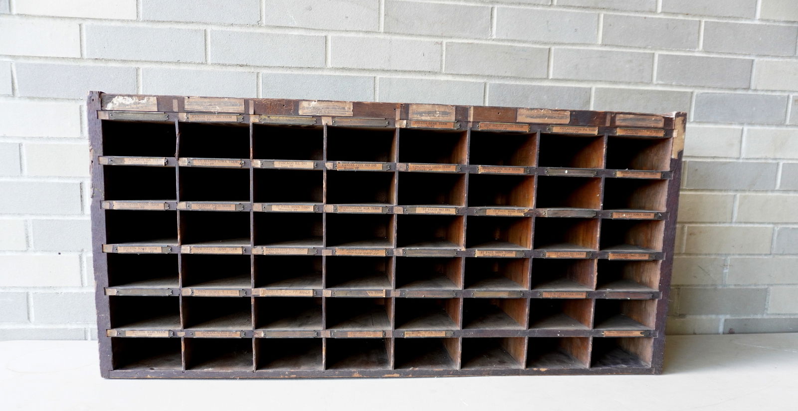 An oak train dispatchers wall hanging cubby hole unit - each unit labeled for train including Omaha: An oak train dispatchers wall hanging cubby hole unit - each unit labeled for train including Omaha Nebraska Terminal, New Haven Conn. Terminal, Birmingham Alabama Terminal, etc. The unit with use wea