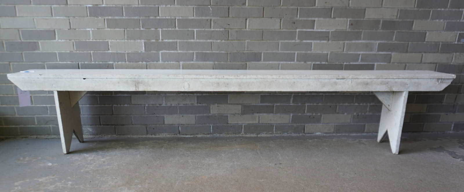 A long primitive pine bench in old white paint, probably mid to late 20th century. Very good: A long primitive pine bench in old white paint, probably mid to late 20th century. Very good condition and sturdy. Measures 96"L x 9 1/2"D x 18 1/4"H. Provenance: From the June & Bernard Pierce estate