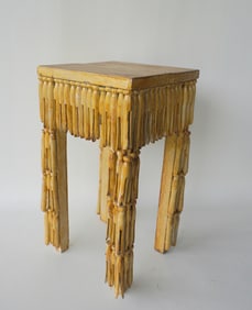 A small folk art table constructed from clothespins in darkened varnish over original paint, circa