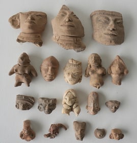 A grouping of 18 ancient terra cotta human sculpture fragments, some probably pre-Columbian and 1