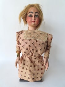 A mechanical folk art ventriloquist wooden doll with head that can be moved from left to right or up