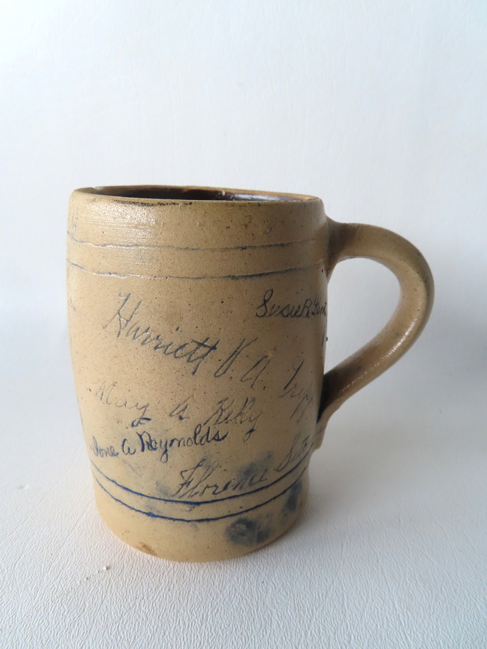 A Vassar College mug signed by a group of students (ladies), probably members of a Vassar sorority,: A Vassar College mug signed by a group of students (ladies), probably members of a Vassar sorority, and incised on base with the signature of Cora Hart, late 19th to early 20th century. It has the mot