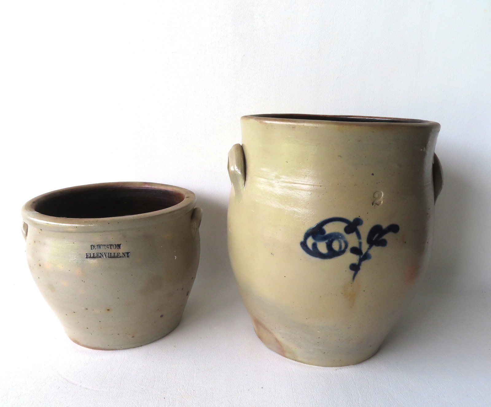 Two stoneware crocks. The first, slightly ovoid with the impressed mark of "D. WESTON / ELLENVILLE: Two stoneware crocks. The first, slightly ovoid with the impressed mark of "D. WESTON / ELLENVILLE NY" - probably 1 gallon size and measures 9" diameter of top x 7"H - very good condition, no damage; 
