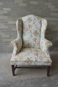 A Hepplewhite style wing chair with stretcher base, probably early 20th century. The upholstery with