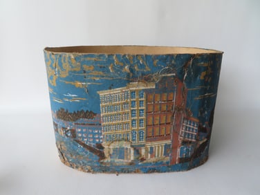 A wall papered band box decorated with a city scene with buildings - a hand sewn repair to one side,