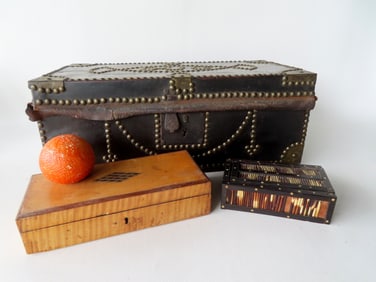 Grouping of 3 primitive boxes including: a leather trunk with brass tacks marked within decoration