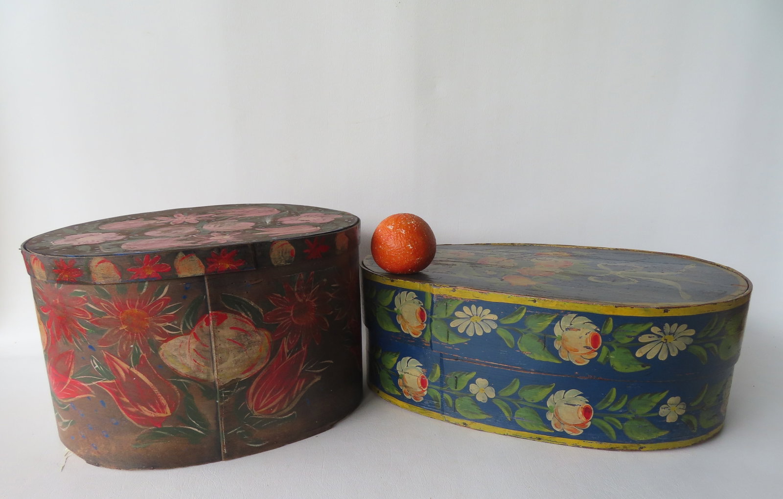Two Scandinavian hand painted boxes. The first, a bride's box decorated with flowers on all sides -: Two Scandinavian hand painted boxes. The first, a bride's box decorated with flowers on all sides - this is the largest measuring 18 1/4"W x 11 1/2"D x 6 1/2"H; the second, a hat box, beautifully deco