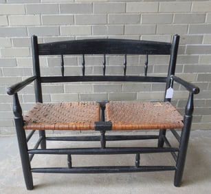 A half-spindle buggy bench with woven cane seat, turned arms, legs and cross stretchers, early to