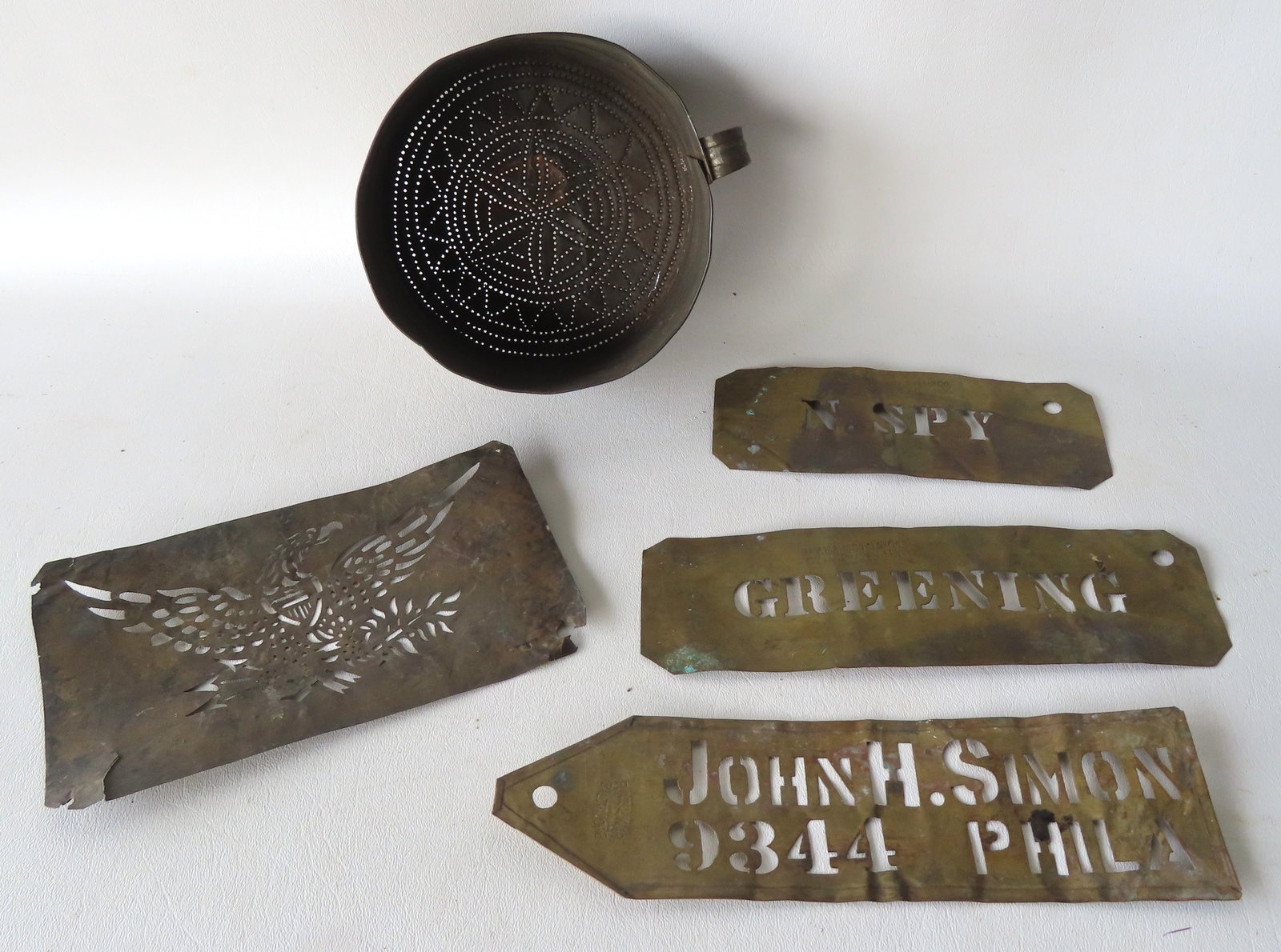 A grouping of country collectibles including a pierced tin sifter decorated win the base with a: A grouping of country collectibles including a pierced tin sifter decorated win the base with a central flower and a saw tooth border, mid 19th century in good condition - measures 6" diameter x 3"H; 