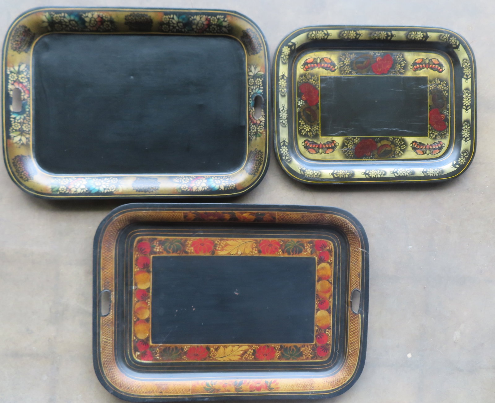 Three 19th century stenciled toleware trays, all in original paint and in good condition. The: Three 19th century stenciled toleware trays, all in original paint and in good condition. The largest measures 26" x 19. Provenance: From the June & Bernard Pierce estate, Hyde Park NY.