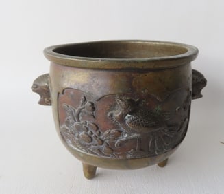 A very fine small oriental patinated bronze planter or pot, decorated with 2 embossed images of