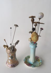 Grouping of vintage hat pins and 2 porcelain hat pin holders. Most in good condition. Provenance: