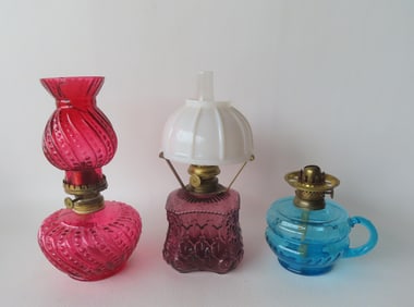 Three Victorian miniature oil lamps. The shade for the cranberry lamp with damage (see photo), else