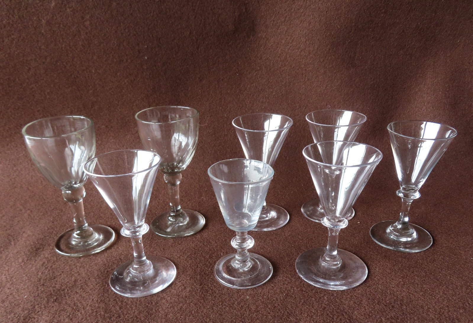 Grouping of 8 early colorless hand blown cordial glasses, 18th/19th century, all without damage in: Grouping of 8 early colorless hand blown cordial glasses, 18th/19th century, all without damage in very good condition. The largest measures 4 3/4"H. Provenance: From an Ulster County NY resident, dow