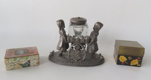Three vintage desk articles including: A figural silver plated inkwell of 2 young girls holding cart