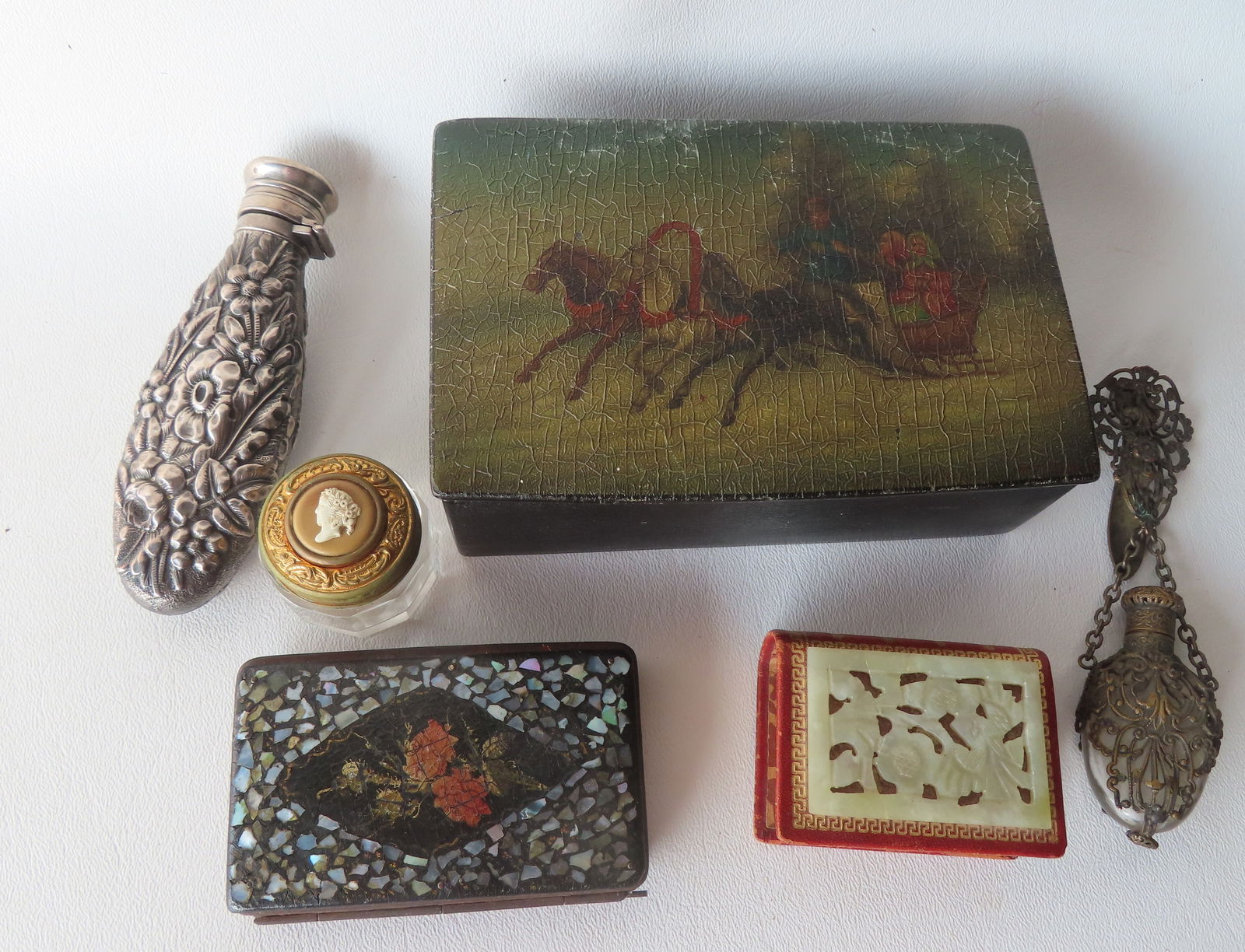 A grouping of vintage decorative collectibles including: A paper mache purse with mother of pearl: A grouping of vintage decorative collectibles including: A paper mache purse with mother of pearl inlays, good condition; a sterling repousse flask, very good condition; a paper mache box, with artwor