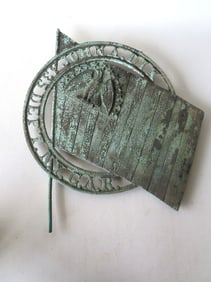 A bronze G.A.R. officer's marker decorated with an embossed eagle over American flag, marked "John