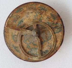 An Astrolabe with lithograph map covering the top below the adjustable brass gauge, cast iron frame,