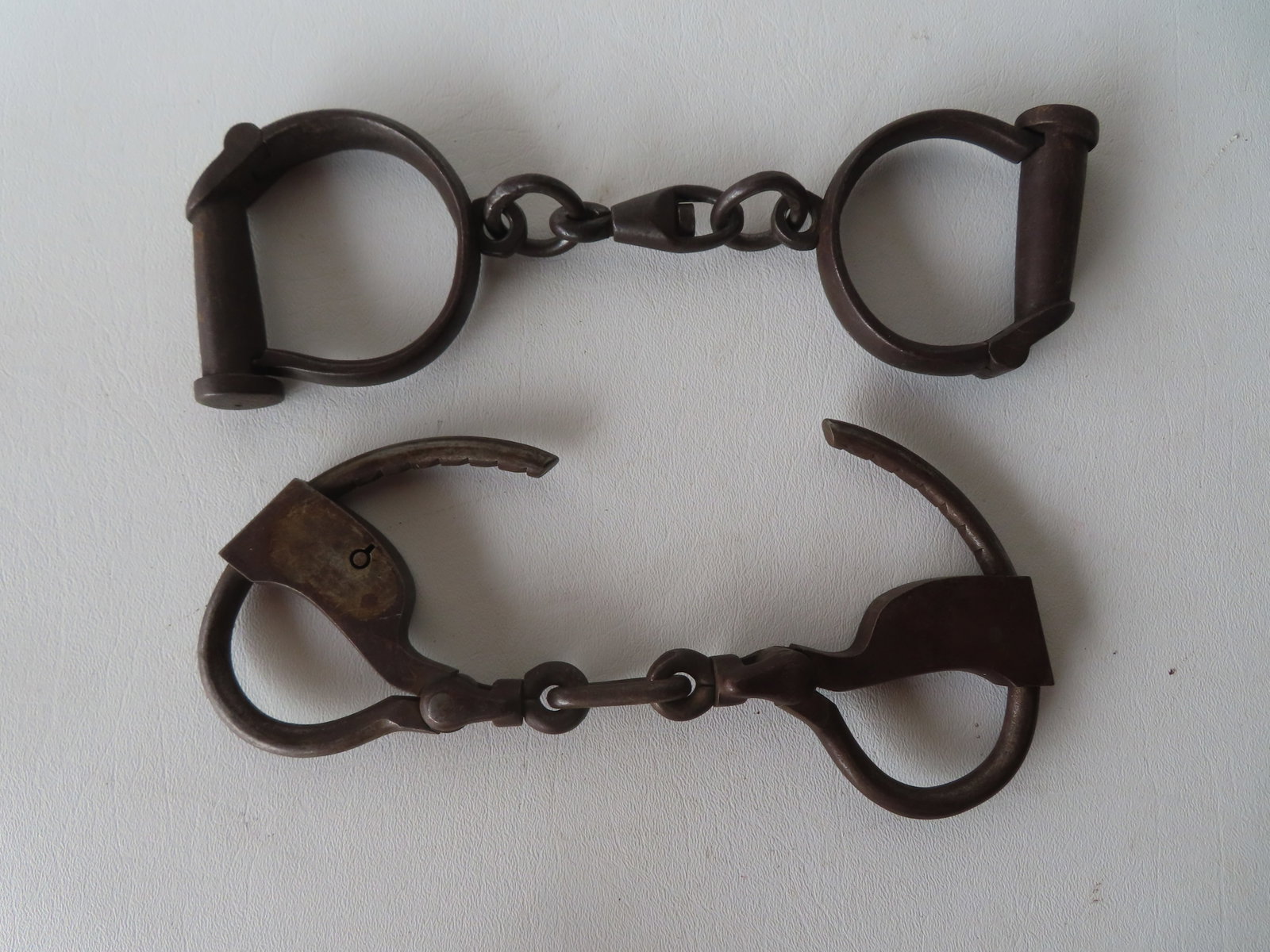Two pair of iron handcuffs believed to be late 19th century, both lacking keys otherwise very good: Two pair of iron handcuffs believed to be late 19th century, both lacking keys otherwise very good condition. The first marked "Hard" with cylindrical lock; the second, marked "Tower's Double Lock". P