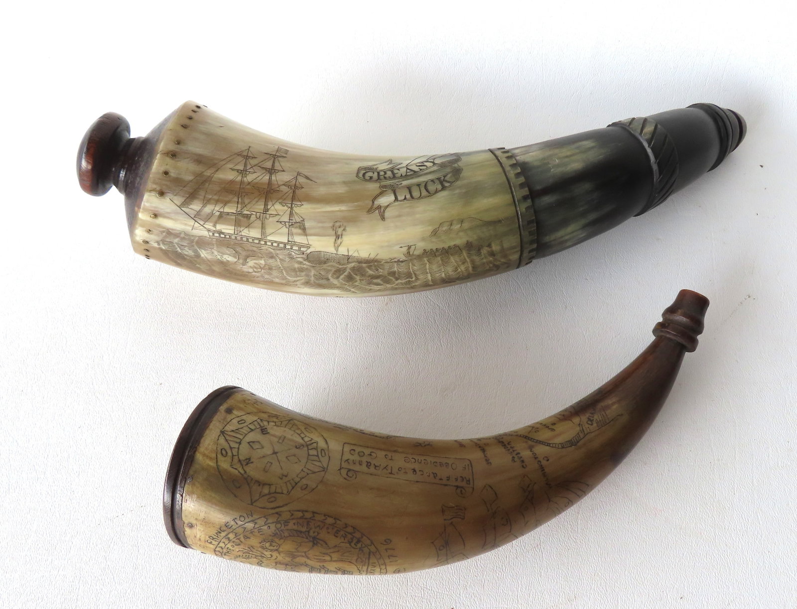 Two scrimshaw powder horns, believed to be 20th century, but with appearance of being 18th/19th: Two scrimshaw powder horns, believed to be 20th century, but with appearance of being 18th/19th century. The first, a scrimshaw carved powder horn, depicting a very detailed whaling scene in the "Bisc