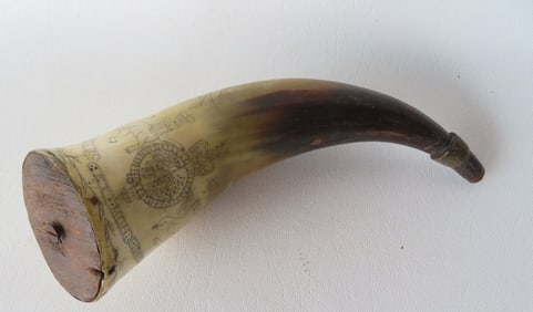 A scrimshaw powder horn signed "SHADRACH BOND / BALTIMORE" in banners above scrimshaw of the city of