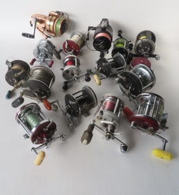 A grouping of 16 vintage fishing reels, some deep sea, and others bait casting reels. Includes