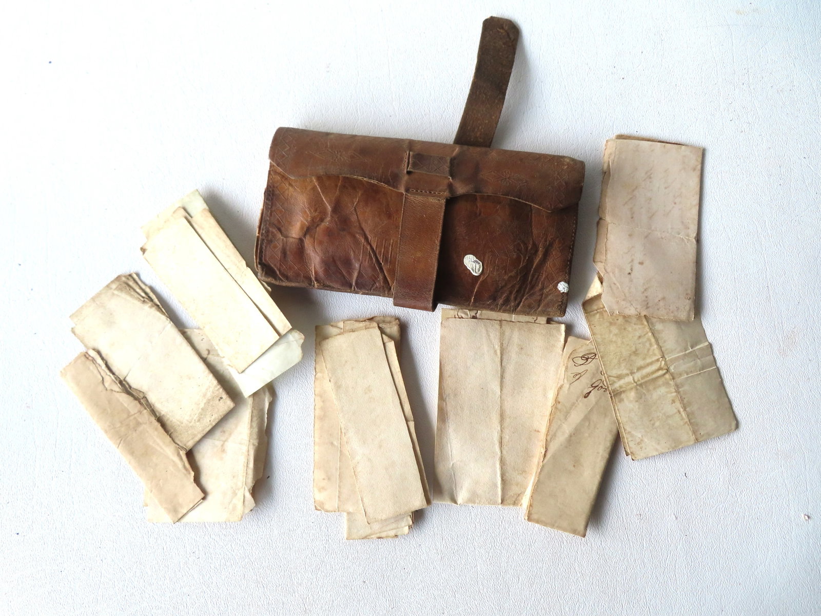 A folding patriotic leather wallet, early 19th century. The back decorated with an image of 2 spread: A folding patriotic leather wallet, early 19th century. The back decorated with an image of 2 spread wing eagles above American shield which are impressed into the leather (probably plate impression t
