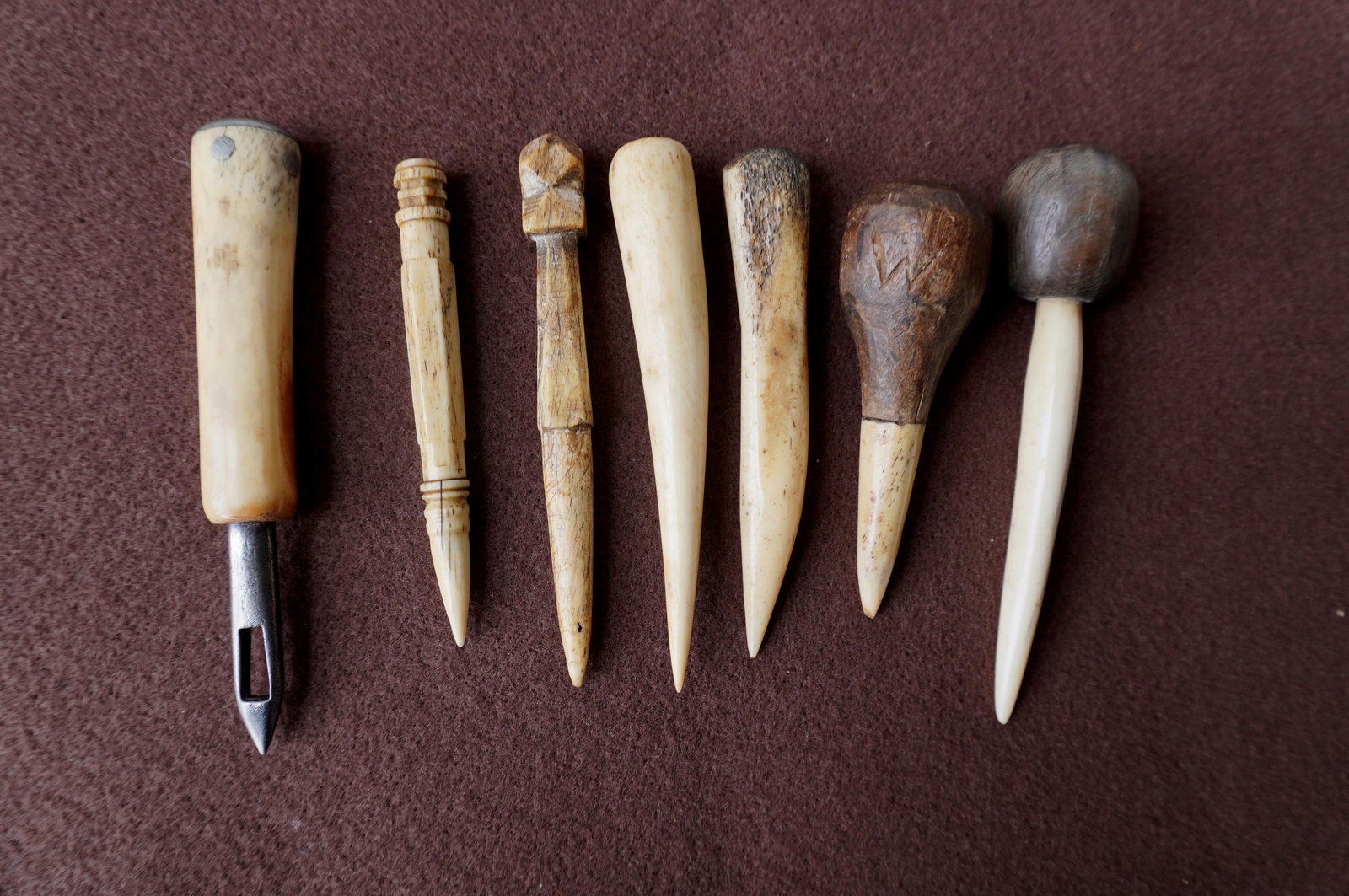 rouping of 6 short whalebone fids, and one whalebone sail maker's sewing awl, 19th century, all with: Grouping of 6 short whalebone fids, and one whalebone sail maker's sewing awl, 19th century, all with use wear and patina consistent with age and in good condition. The largest 5 1/4"L. Provenance: Fr