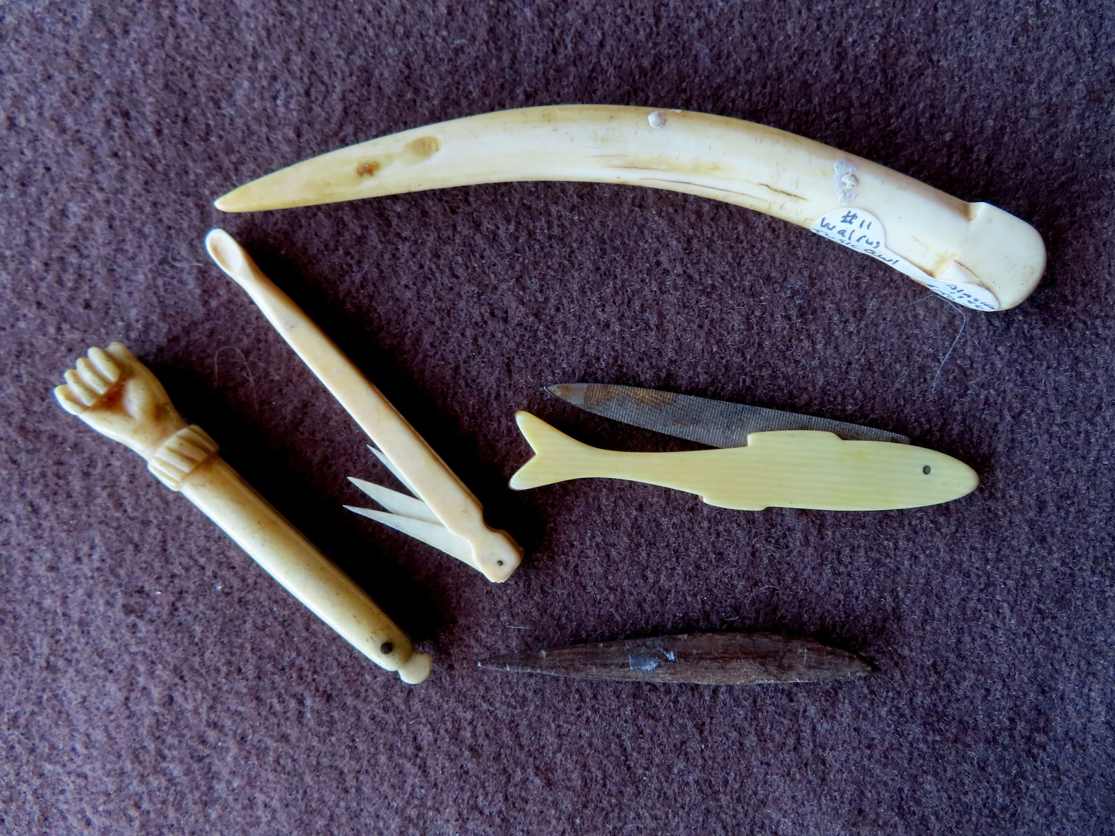 Grouping of 4 whalebone tools, 19th century, all with good patina and use wear consistent with age a: Grouping of 4 whalebone tools, 19th century, all with good patina and use wear consistent with age and in good condition - the largest, a bodkin, measures 5 1/2"L; together with a faux ivory (Celluloi