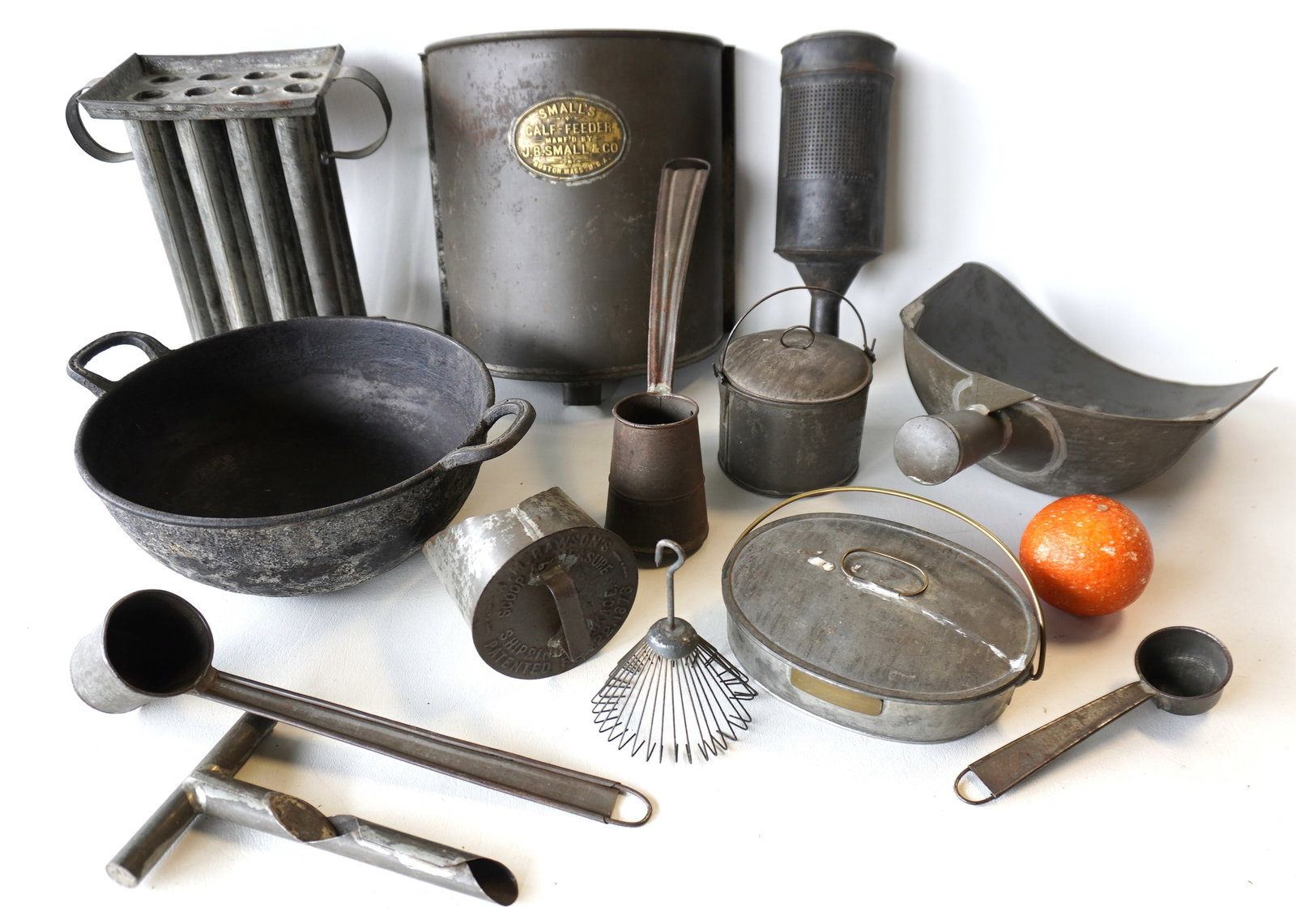 Large grouping of early tinware including: Dinner pail with brass tag marked "David Howarth /: Large grouping of early tinware including: Dinner pail with brass tag marked "David Howarth / Portland, Me. / Dinner Pail" (no burner) - 7 1/2"L x 5 1/2"W; a "Small's Calf-Feeder / Manf'd by J.B. Smal