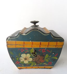 A very fine early toleware tea caddy in original paint decorated with flowers and a mustard block