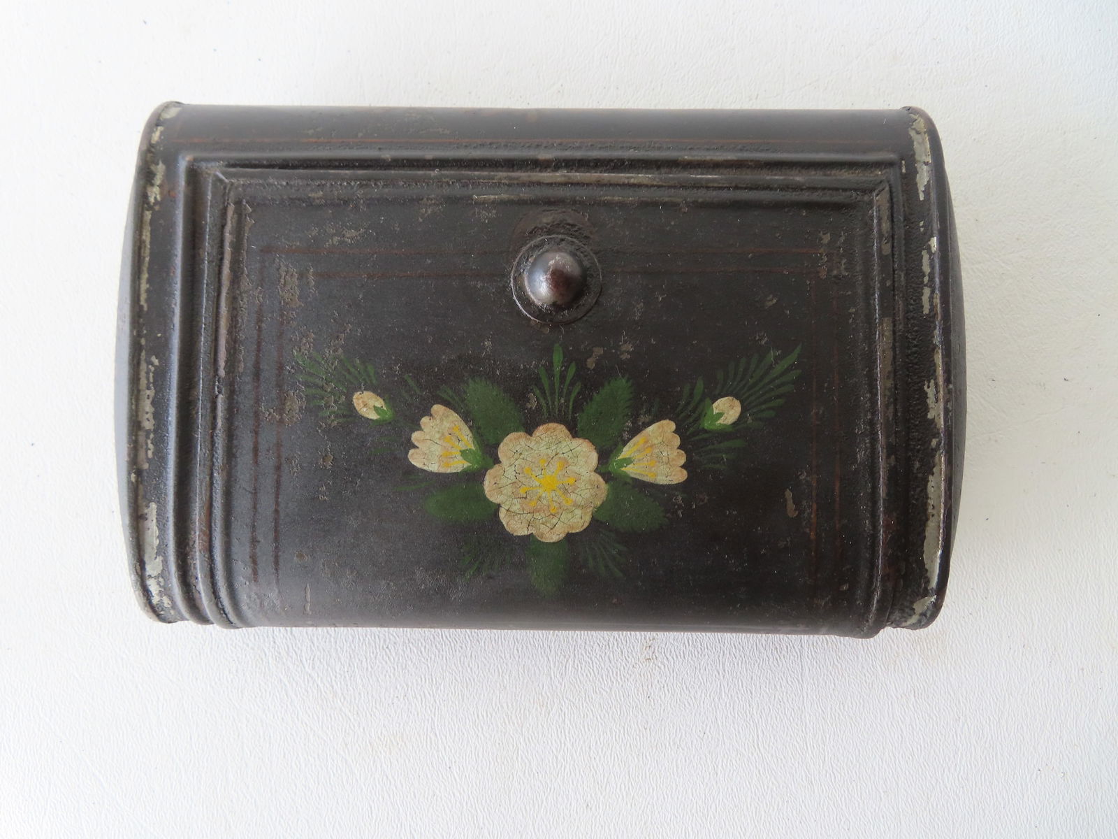 An unusual cylindrical toleware box with door, decorated with hand painted flowers, early 19th: An unusual cylindrical toleware box with door, decorated with hand painted flowers, early 19th century in very good condition. Currently being used to hold a prayer book. Measures 7"L x 4 1/4"D x 1 3/